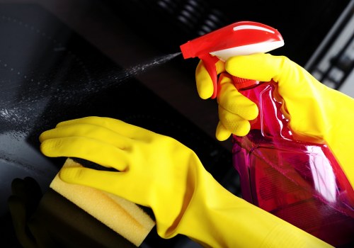 Domestic cleaner organizing household surfaces in a bright kitchen