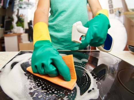 Professional carpet cleaner treating stains on a carpet