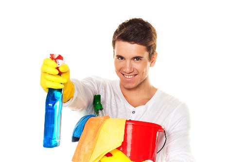Cleaner organizing kitchen surfaces during a home cleaning visit